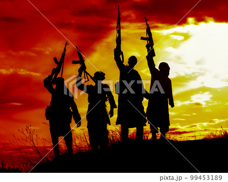 Silhouette of several muslim militants with rifles 99453189