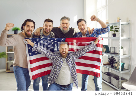 Happy father and sons with American flag celebrating US Independence Day together 99453341