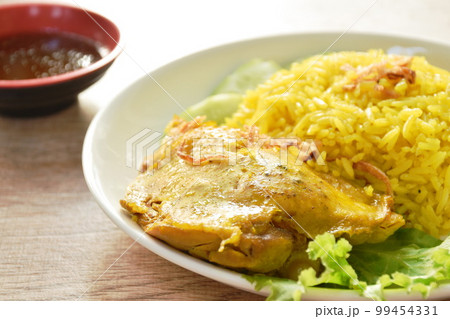 biryani rice cooked with chicken in curry on plate dipping spicy chili sauce 99454331