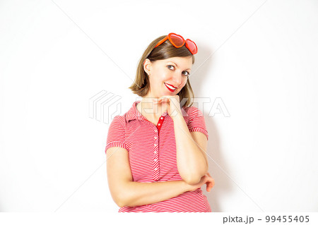 Attractive young girl with red heart sunglasses standing and smiling. Valentines Day concept. High quality photo. 99455405