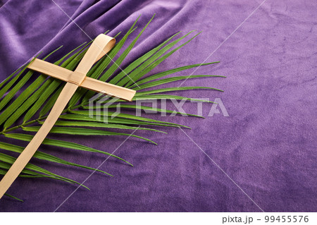 Lent season, Holy week and Good friday concept. Palm leave and cross on purple background 99455576