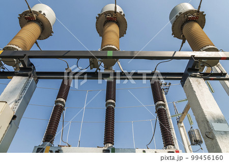Part of high-voltage substation on blue sky background with switches and disconnectors. Ukrainian energy infrastructure. 99456160