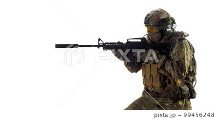 Cropped photo of a mercenary soldier with an automatic rifle in his hand aiming in enemy. Cropped photo of a mercenary soldier with an automatic rifle in his hand aiming in enemy. 99456248