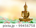 Makha Asanaha Visakha Bucha Day Golden Buddha image. Background of Bodhi leaves with shining light. Soft image and smooth focus style 99456758