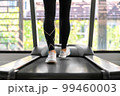 young happy asian woman athlete run on treadmill, running machine, in indoor gym fitness for health; 99460003