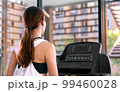 young happy asian woman athlete run on treadmill, running machine, in indoor gym fitness for health; 99460028