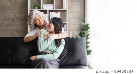 Mother and daughter hugging at home. Happy senior mom and adult daughter embracing with love 99460234