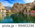 Croatia, City of Omis, a popular tourist destination for trekking and rafting on the Cetina river. Mountains, river, pleasure boats. 99463286