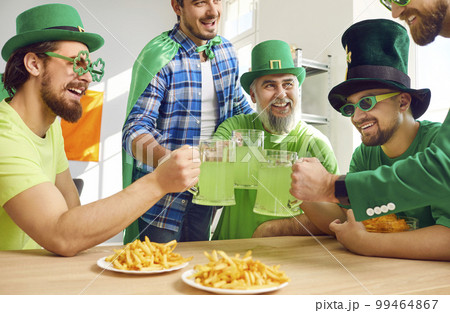 Group of happy men celebrating Patrick's Day, drinking green beer, and having fun 99464867