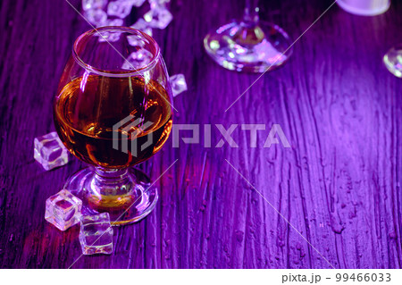 Cocktail drinks with ice in club lights 99466033