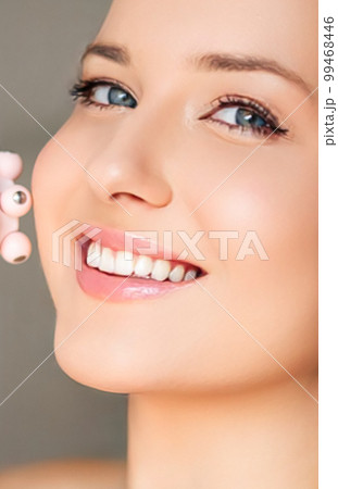 Anti-aging cosmetology and beauty treatment product, woman using face contour massage roller device as facelift procedure and skincare routine, close-up Anti-aging cosmetology and beauty treatment product, woman using face contour massage roller device as facelift procedure and skincare routine, close-up 99468446