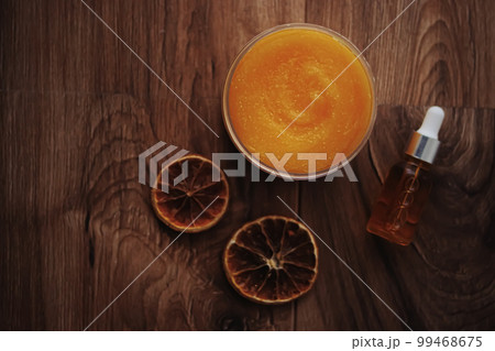 Citrus and honey orange body scrub jar on rustic wood background, beauty cosmetic and skincare product. Citrus and honey orange body scrub jar on rustic wood background, beauty cosmetic and skincare product. 99468675