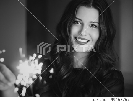 Holiday magic, Christmas and New Year celebration, happy woman with sparklers, portrait Holiday magic, Christmas and New Year celebration, happy woman with sparklers, portrait 99468767