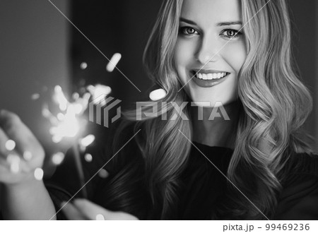 Holiday magic, Christmas and New Year celebration, happy woman with sparklers, portrait 99469236