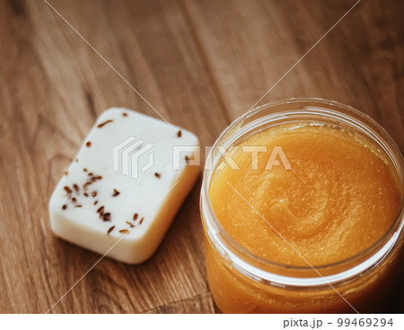 Citrus and honey orange body scrub jar on rustic wood background, beauty cosmetic and skincare product. Citrus and honey orange body scrub jar on rustic wood background, beauty cosmetic and skincare product. 99469294