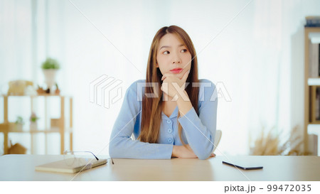 Distracted from work worried young asian woman thinking of problems 99472035