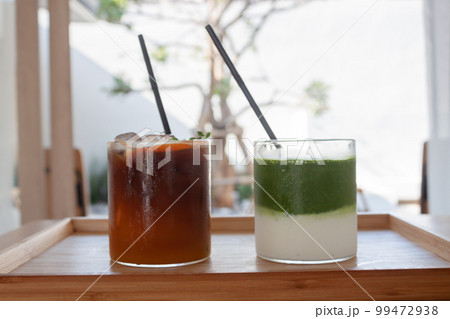 Iced americano with orange and iced matcha green tea in coffee shop Iced americano with orange and iced matcha green tea in coffee shop 99472938
