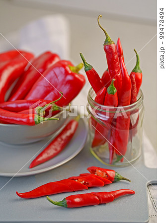 Grey background with chili pepper. Red, hot. Capsicum. Seasoning. Spice. Mexican. Element for the design. 99478494