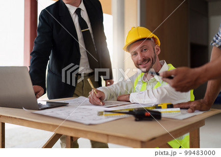 Civil Construction team working at renovate construction site. architectural plan, engineer sketching a construction project, green energy concept. 99483000