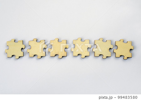 A mock-up of six blank wooden puzzles on a white background for your text or design. For brainstorming. 99483580