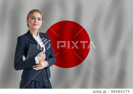 Japanese businesswoman on the flag of Japan digital nomad, business, startup concept Japanese businesswoman on the flag of Japan digital nomad, business, startup concept 99484275
