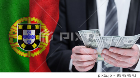 Hands holding dollar money on flag of Portugal 99484943