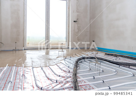installation of concrete and anhydrite on underfloor heating in a room of a newly built family house 99485341