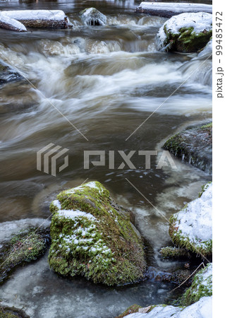 Little cascade with ice. River in cold snowy winter Little cascade with ice. River in cold snowy winter 99485472