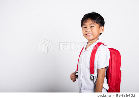 Asian adorable toddler smiling happy wearing student thai uniform standing in studio shot isolated on white background, Portrait little children boy preschool, Happy child Back to school 99486402