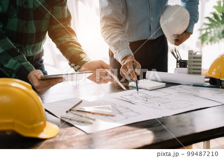 Engineer Teamwork Meeting, Drawing working on blueprint meeting for project working with partner on model building. Engineer Teamwork Meeting, Drawing working on blueprint meeting for project working with partner on model building. 99487210