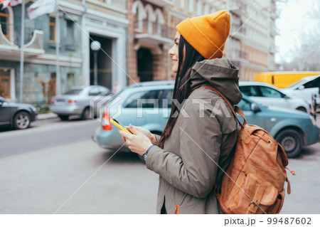 Young woman tourist with a backpack Young woman tourist with a backpack 99487602