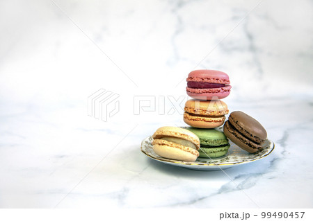French Colorful Macarons Colorful Pastel Macarons on White Background pastel Pink and Brown Macaron with Fresh Blueberry, sweet cake stack copy space French Colorful Macarons Colorful Pastel Macarons on White Background pastel Pink and Brown Macaron with Fresh Blueberry, sweet cake stack copy space 99490457