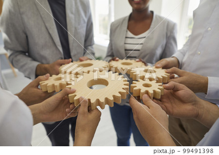 Business team connecting cog wheels to show the concept of cooperation and teamwork Business team connecting cog wheels to show the concept of cooperation and teamwork 99491398
