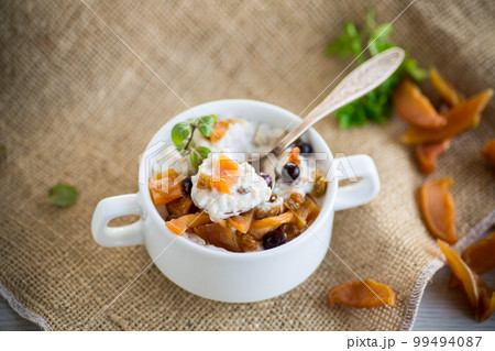 oatmeal with candied fruits, raisins in a plate oatmeal with candied fruits, raisins in a plate 99494087