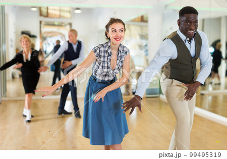 Woman and man dancing swing in studio 99495319