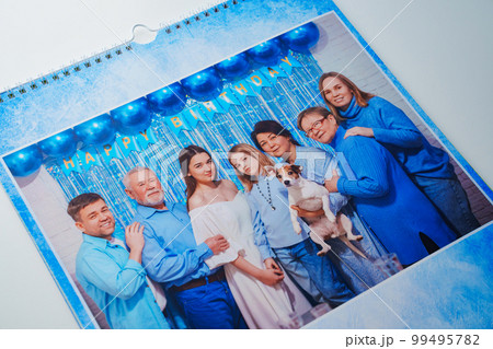 a flip calendar with family photos with dog. 99495782