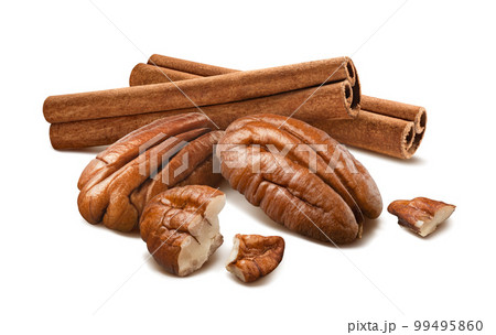 Pecan nuts and cinnamon sticks isolated on white background 99495860