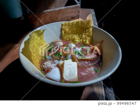 Yentafo egg noodles soup with pink sauce and Fish balls, Shrimp, Fresh squid, Fresh squid, Pickled squid, Jellyfish, Tofu and Fried wontons. 99496547