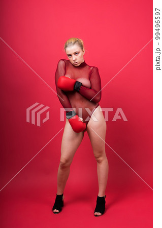 Boxer, seductive confident female boxer with gloves studio, sporty woman posing looking at camera. 99496597