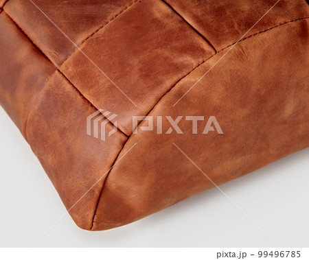 Handmade half-cylindrical footrest cushion from copper-colored leather patches 99496785