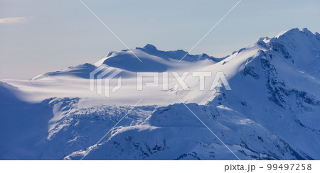 Snow and Cloud covered Canadian Nature Landscape Mountains Background. Whistler 99497258