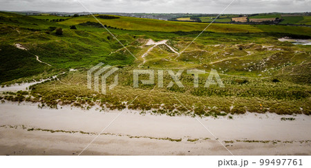Picturesque sand hills of Ireland, top view. Sand dunes covered with vegetation. Irish landscape. Picturesque sand hills of Ireland, top view. Sand dunes covered with vegetation. Irish landscape. 99497761