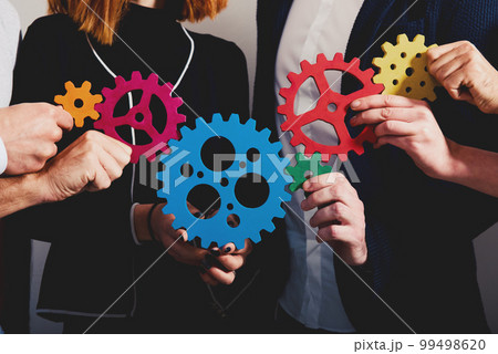 Business team connect pieces of gears. Teamwork, partnership and integration concept 99498620