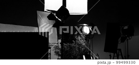 Film light for video production camera in studio set. Use as studio photo shoot light. Big LED spot light 5000w and diffuser or black panel create light like sun light can make daytime or golden hour 99499330