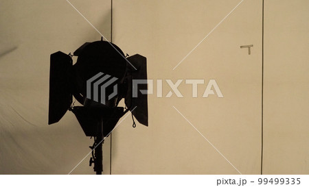Film light for video production camera in studio set. Use as studio photo shoot light. Big LED spot light 5000w and diffuser or black panel create light like sun light can make daytime or golden hour Film light for video production camera in studio set. Use as studio photo shoot light. Big LED spot light 5000w and diffuser or black panel create light like sun light can make daytime or golden hour 99499335