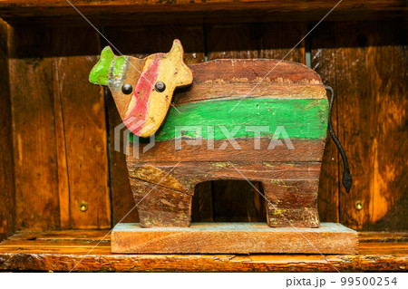Painted simple funny wooden cow figurine as a vintage interior element Painted simple funny wooden cow figurine as a vintage interior element 99500254