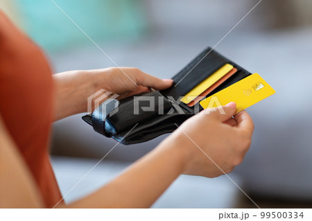 Unrecognizable Female Holding Leather Wallet And Taking Out Bank Credit Card 99500334