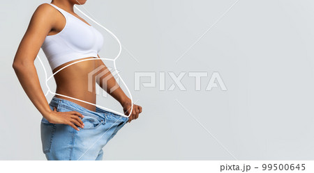 Millennial slim african american lady in big jeans, enjoy weight loss result with fat abstract body around Millennial slim african american lady in big jeans, enjoy weight loss result with fat abstract body around 99500645