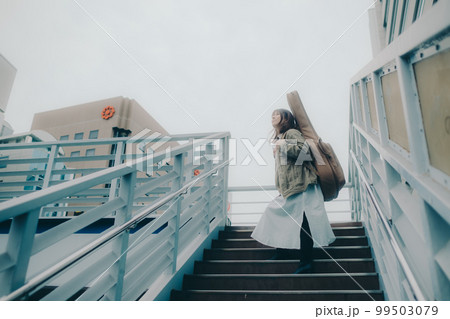 陸橋に佇むギターを持った女性の写真 陸橋に佇むギターを持った女性の写真 99503079