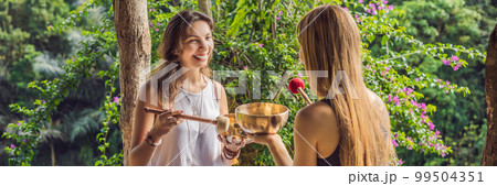 BANNER, LONG FORMAT Nepal Buddha copper singing bowl at spa salon. Young beautiful woman doing massage therapy singing bowls in the Spa against a waterfall. Sound therapy, recreation, meditation BANNER, LONG FORMAT Nepal Buddha copper singing bowl at spa salon. Young beautiful woman doing massage therapy singing bowls in the Spa against a waterfall. Sound therapy, recreation, meditation 99504351